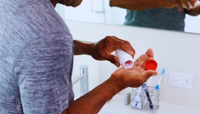 man drinking pill